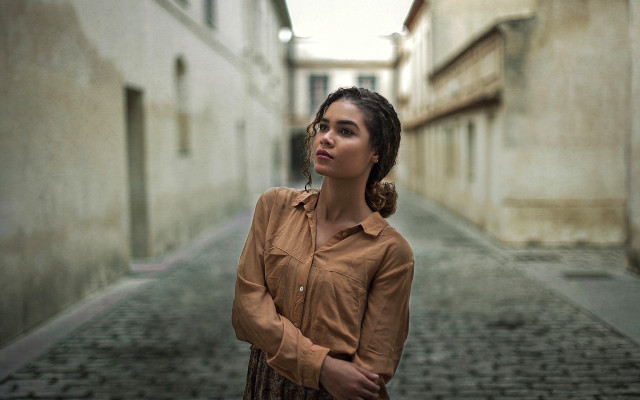 Woman alleyway brown shirt serious free wallpaper - medium preview image