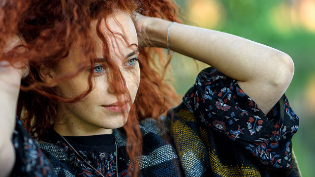 Red haired woman posing blowing free wallpaper - medium preview image