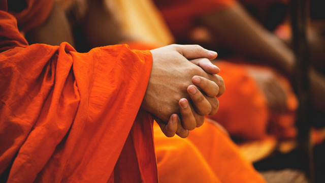 Couple holding hands orange robes free wallpaper - medium preview image