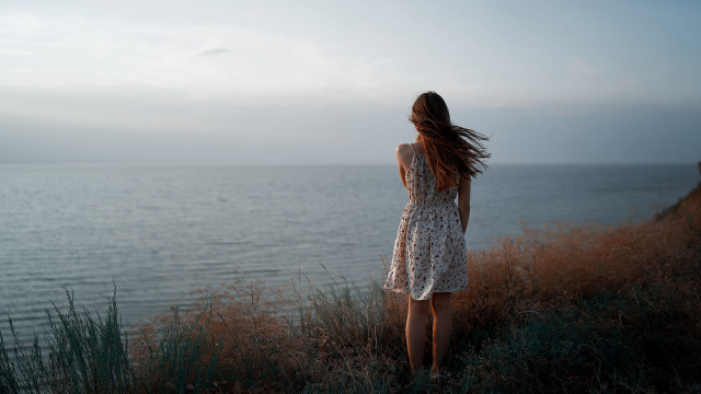Woman cliff ocean wind dress free wallpaper - medium preview image