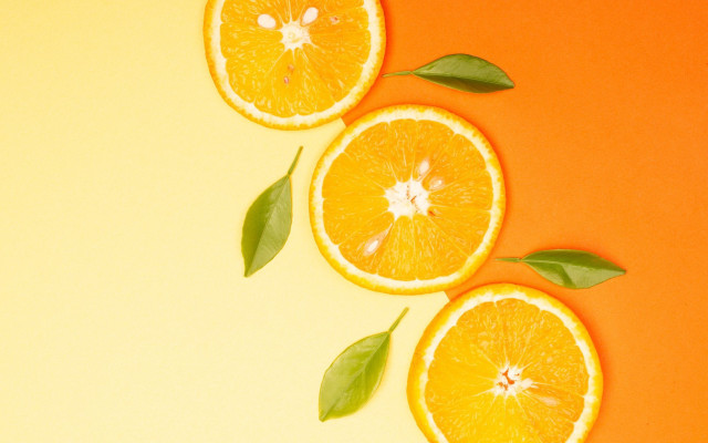 Three oranges leaves yellow background free wallpaper - medium preview image