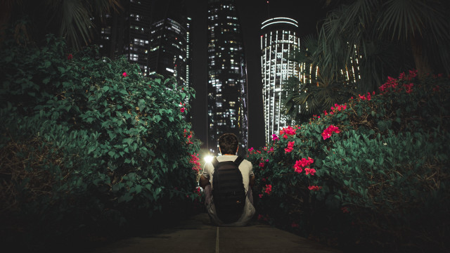 Night cityscape man walking backpack free wallpaper - medium preview image