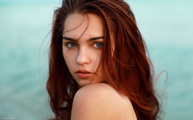 Woman red hair ocean serious free wallpaper - medium preview image