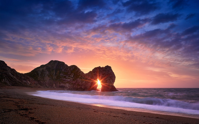 Beach sunset surfboard rock formation free wallpaper - medium preview image