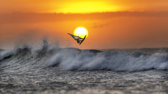 Surfing wave ocean sunset mountain free wallpaper - medium preview image