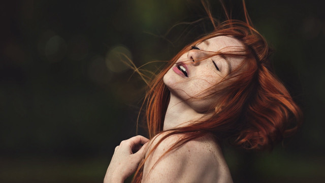 Red haired woman smiling blowing free wallpaper - medium preview image