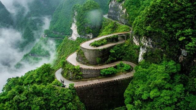 Mountain road cliff person scene free wallpaper - medium preview image