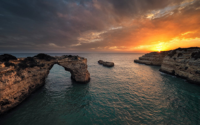 Sunset water rock arch beach free wallpaper - medium preview image