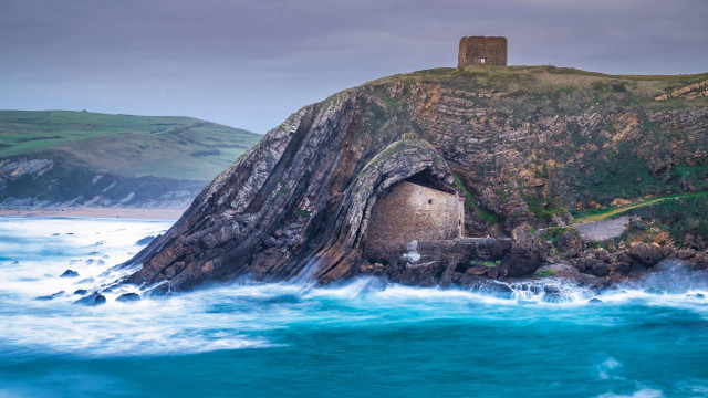 Rock outcropping building ocean tilt free wallpaper - medium preview image