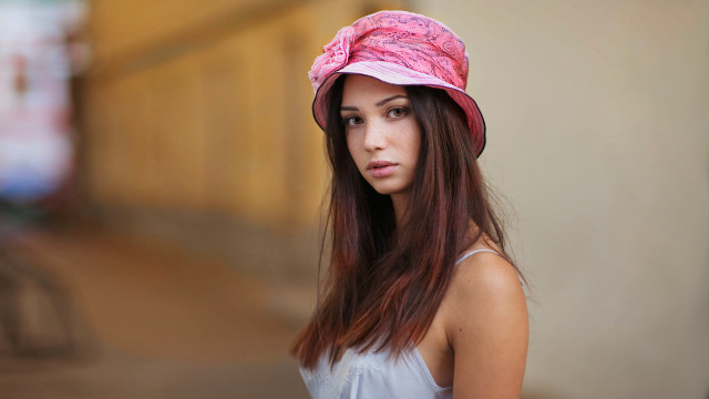 Woman pinkhat whiteshirt building portrait free wallpaper - medium preview image