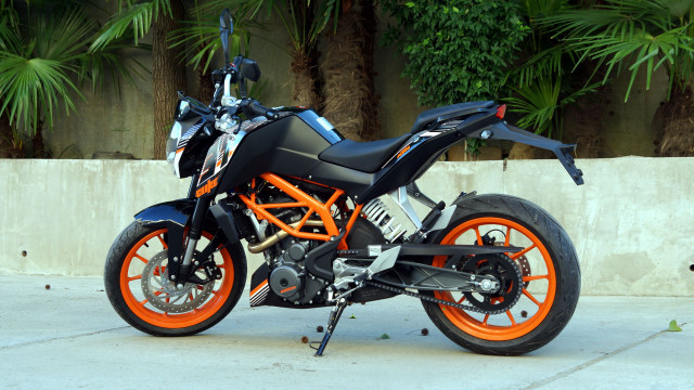 Motorcycle parked sidewalk trees orange free wallpaper - medium preview image