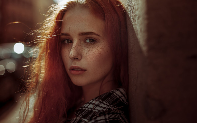 Freckled woman leaning wall serious free wallpaper - medium preview image