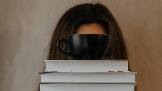 Woman hiding books coffee art free wallpaper - medium preview image