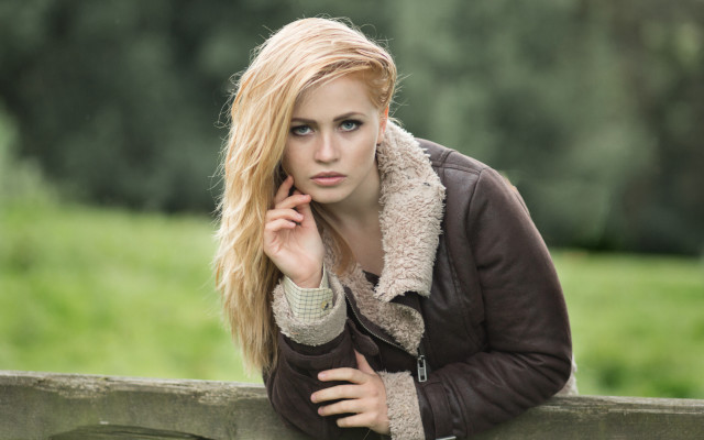 Woman leaning fence serious portrait free wallpaper - medium preview image