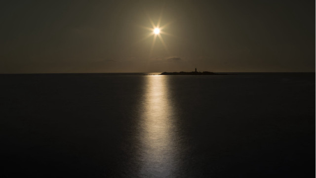 Bright sun ocean night lighthouse free wallpaper - medium preview image