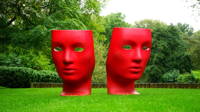 Red faces in grass fence free wallpaper - medium preview image