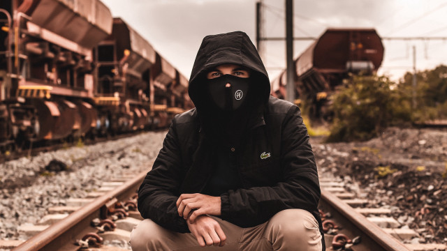 Man black hoodie train track free wallpaper - medium preview image