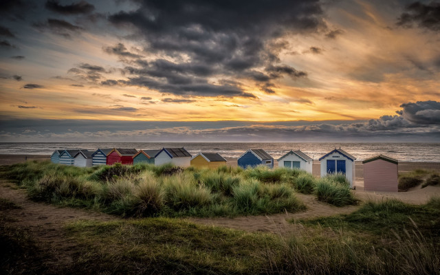 Beach huts grass ocean cloudy free wallpaper - medium preview image