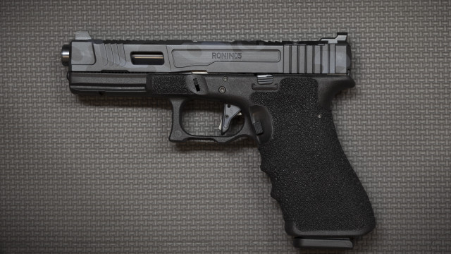 Black gun on table realistic free wallpaper - medium preview image