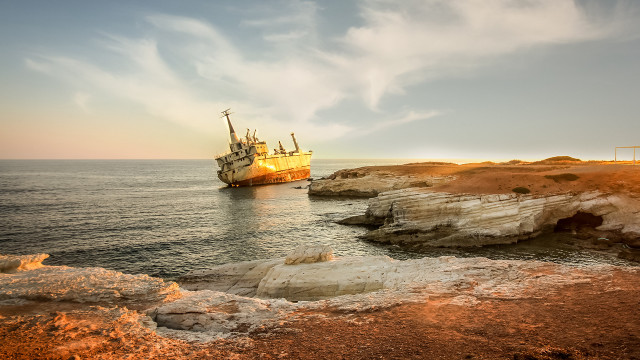 Large boat rocky shore cliff free wallpaper - medium preview image