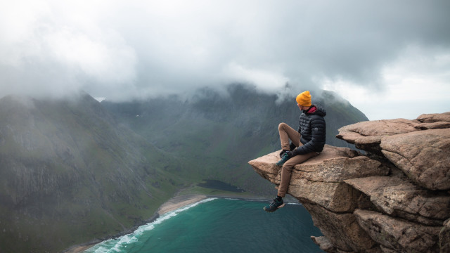 Man yellowhat cliff water mountains free wallpaper - medium preview image