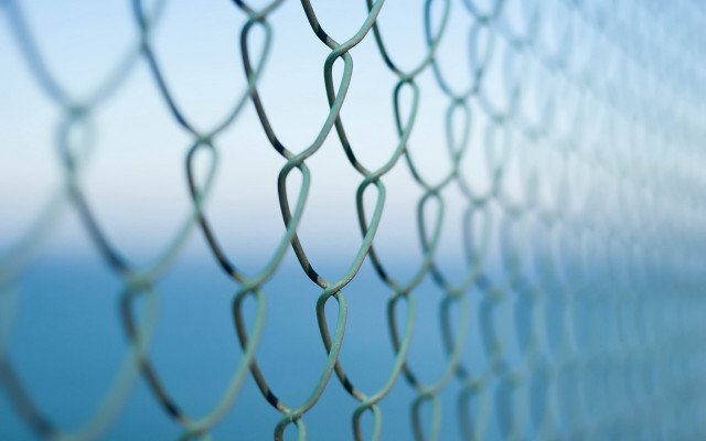 Chain link fence ocean blurry free wallpaper - medium preview image