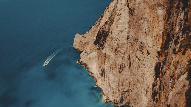 Boat cliff water cinematic photorealism free wallpaper - medium preview image