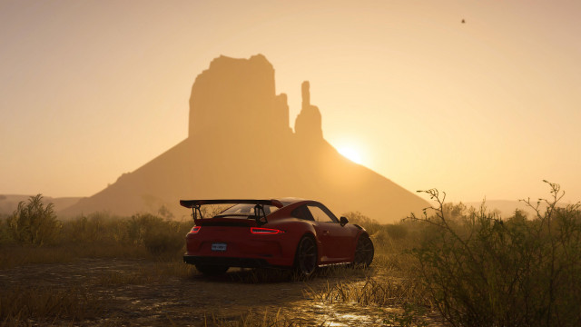 Red sports car field mountain free wallpaper - medium preview image