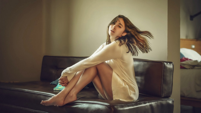 Woman sitting couch blowing wind free wallpaper - medium preview image