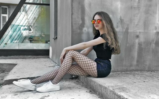 Woman fishnets sunglasses ledge building free wallpaper - medium preview image