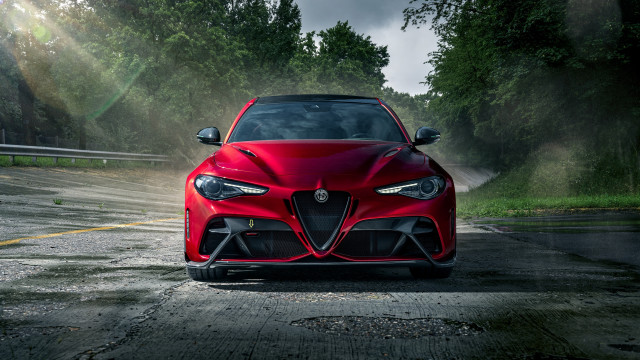 Red sports car driving forest free wallpaper - medium preview image