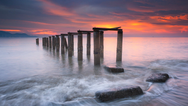Wooden posts ocean sunset red free wallpaper - medium preview image