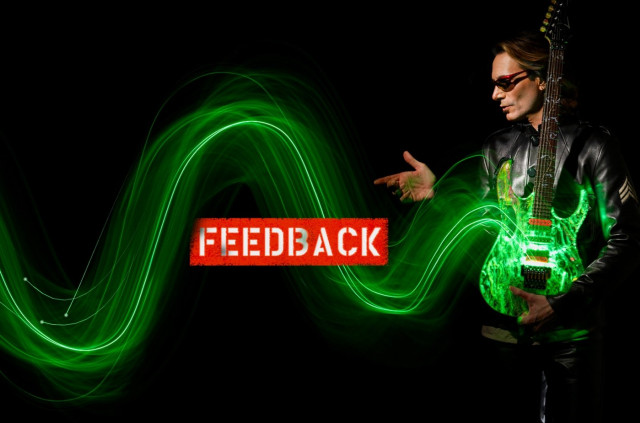 Man holding guitar pointing feedback free wallpaper - medium preview image