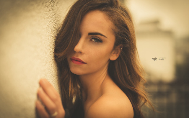 Woman leaning wall long hair free wallpaper - medium preview image