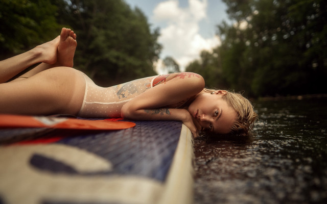 Tattooed woman surfboard water blurry free wallpaper - medium preview image