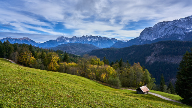Grassy hill cabin mountains clouds free wallpaper - medium preview image