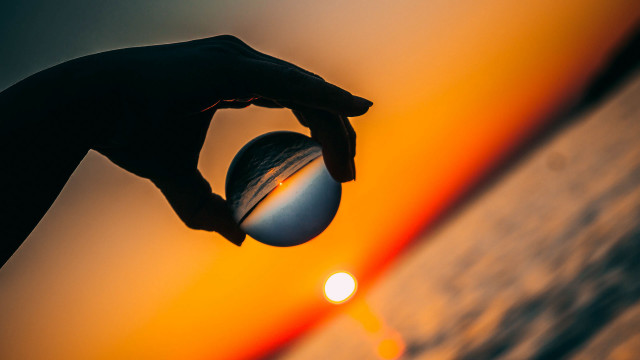 Sunset person holding ball optical free wallpaper - medium preview image