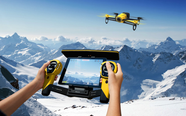Person holding tablet remote flying free wallpaper - medium preview image