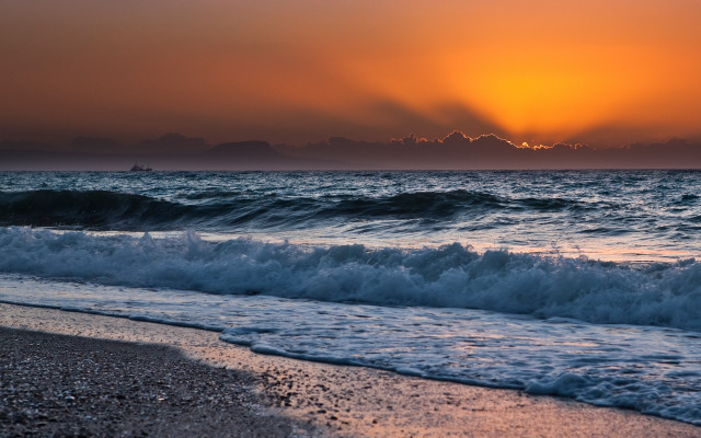Sunset ocean waves boat mountains free wallpaper - medium preview image