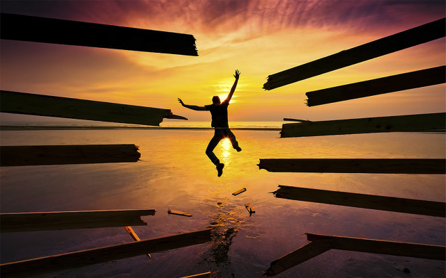 Man jumping over water sunset free wallpaper - medium preview image