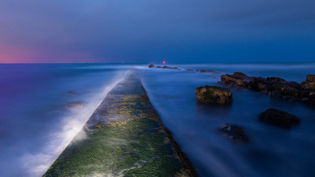 Lighthouse beach water rocks night free wallpaper - medium preview image