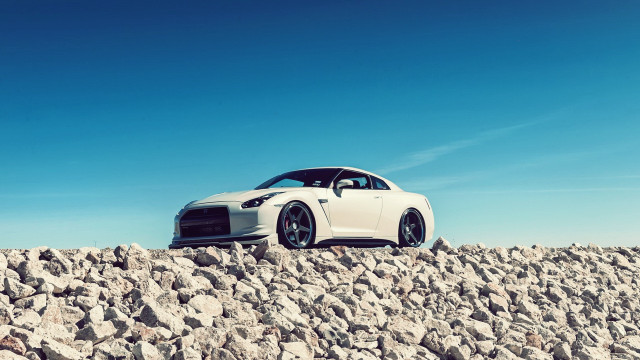 White car rocky surface tilt free wallpaper - medium preview image