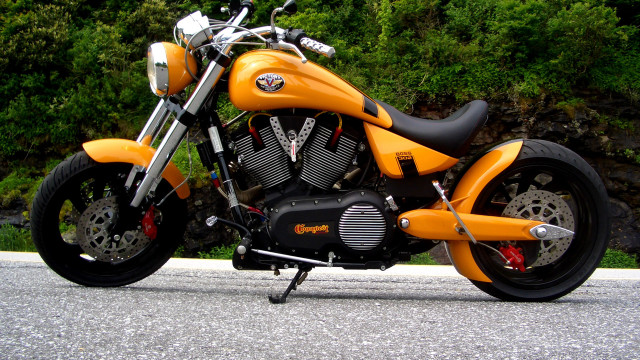 Yellow motorcycle roadside hillside trees free wallpaper - medium preview image