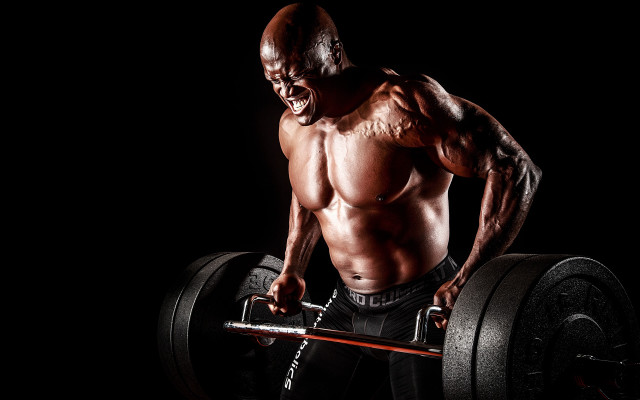 Muscular man barbell black background free wallpaper - medium preview image