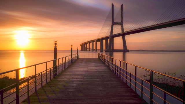 Sunset bridge lighthouse ocean mountain free wallpaper - medium preview image