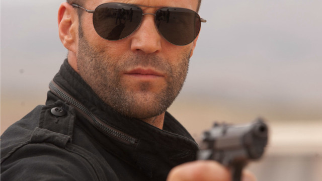 Serious man with sunglasses holding free wallpaper - medium preview image