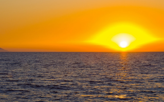 Sunset ocean boat mountain yellow free wallpaper - medium preview image