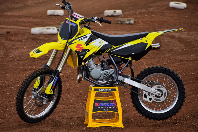 Yellow dirt bike dusty motion free wallpaper - medium preview image