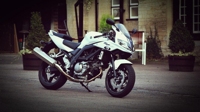 White motorcycle parked street building free wallpaper - medium preview image