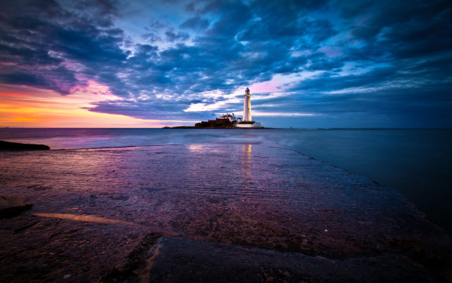 Lighthouse rocky shore sunset clouds free wallpaper - medium preview image